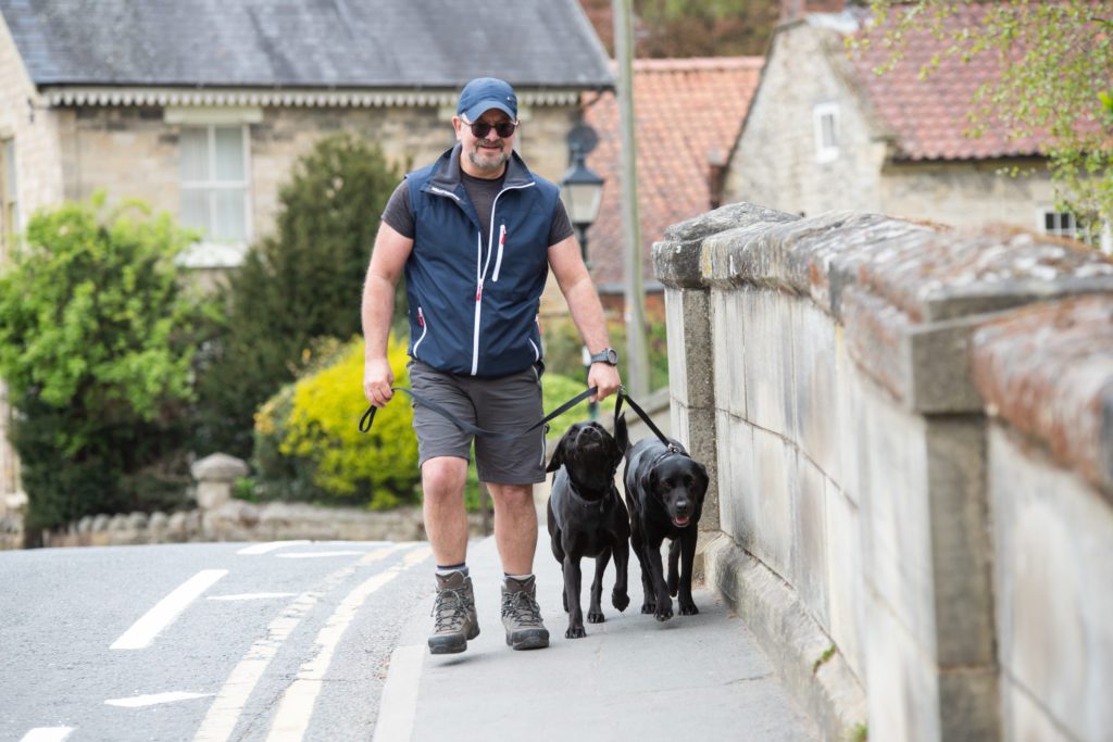 A dog walker in a one of Yorkshire's dog-friendly market towns